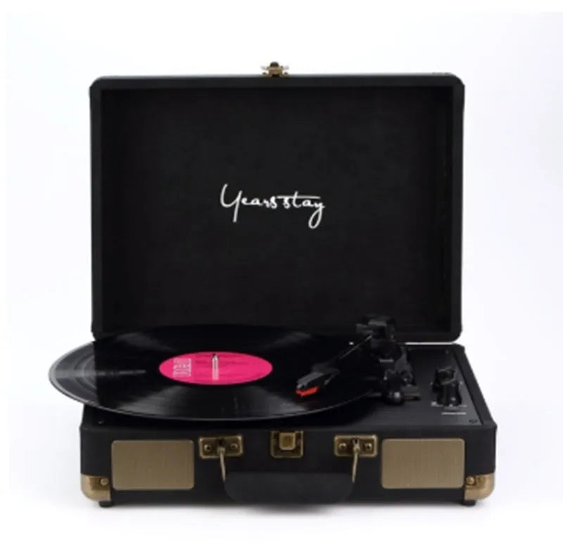 Portable Bluetooth phonograph turntable in a leather case, showing colour options.