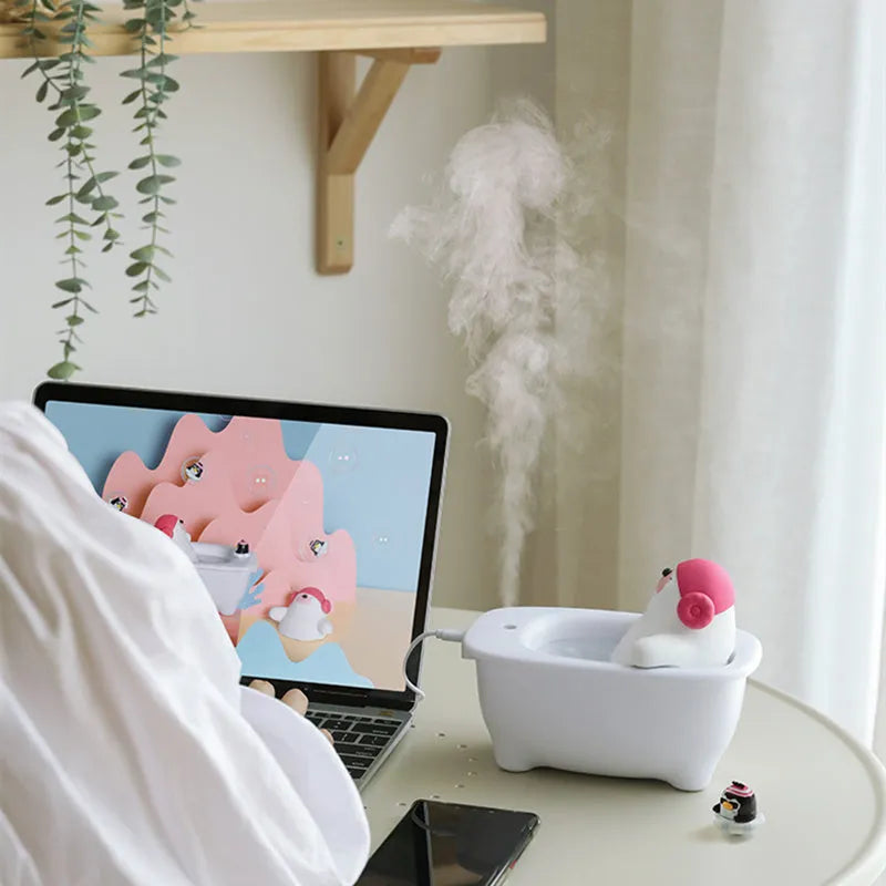 White plastic USB air humidifier with water tank on a desk