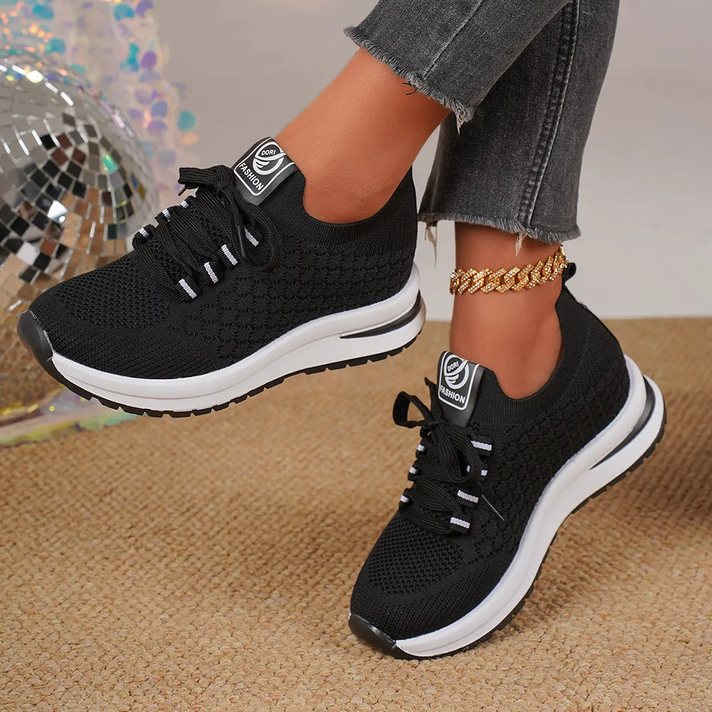 Women's black and white mesh lace-up flat pumps with a round toe and rubber sole.