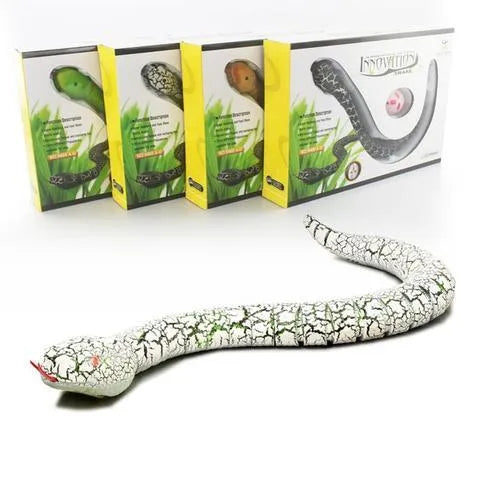 Novelty Remote Control Snake in green colour, 38 cm plastic toy with retractable tongue on a wooden floor