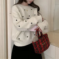Women's loose acrylic pullover sweater with embroidered love pattern in beige, long sleeves and crew neck.