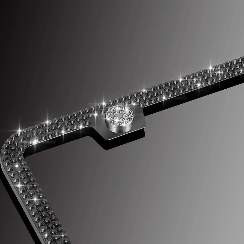 White diamond-studded stainless steel licence plate frame on a car showing 160x310mm external size