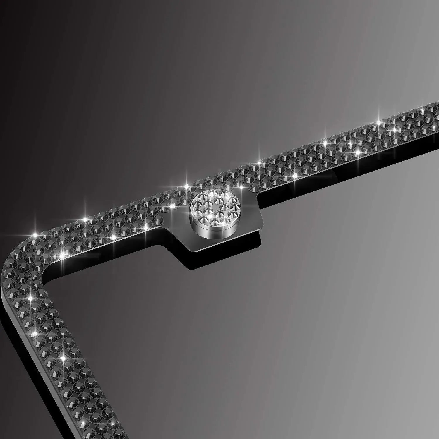 White diamond-studded stainless steel licence plate frame on a car showing 160x310mm external size