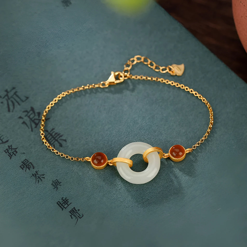 Women's S925 sterling silver gold-plated bracelet with inlaid natural Hetian jade and a peace buckle clasp.
