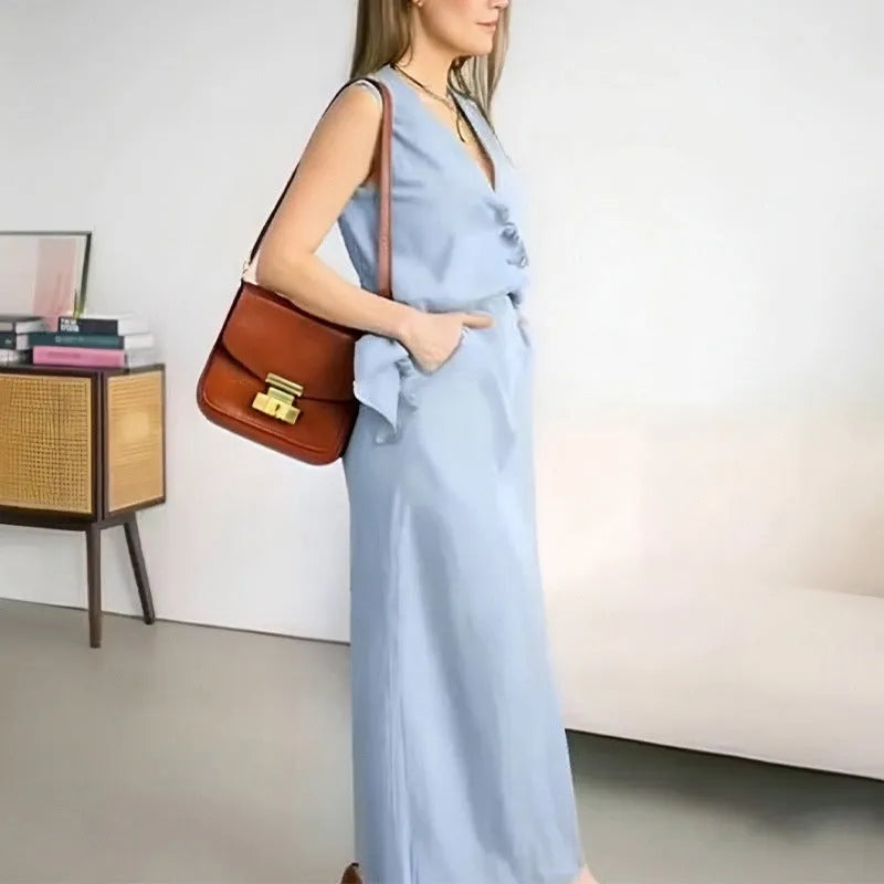 A woman's blue sleeveless vest and long skirt two-piece suit on a hanger.