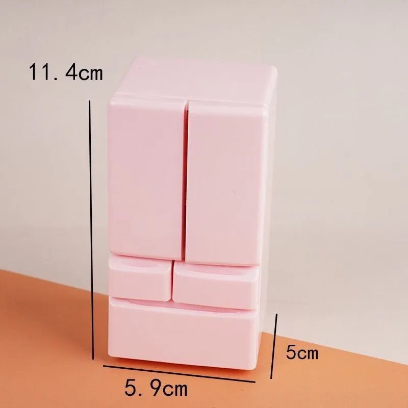 White plastic miniature candy toy model with light feature turned on, shown next to a ruler for scale.