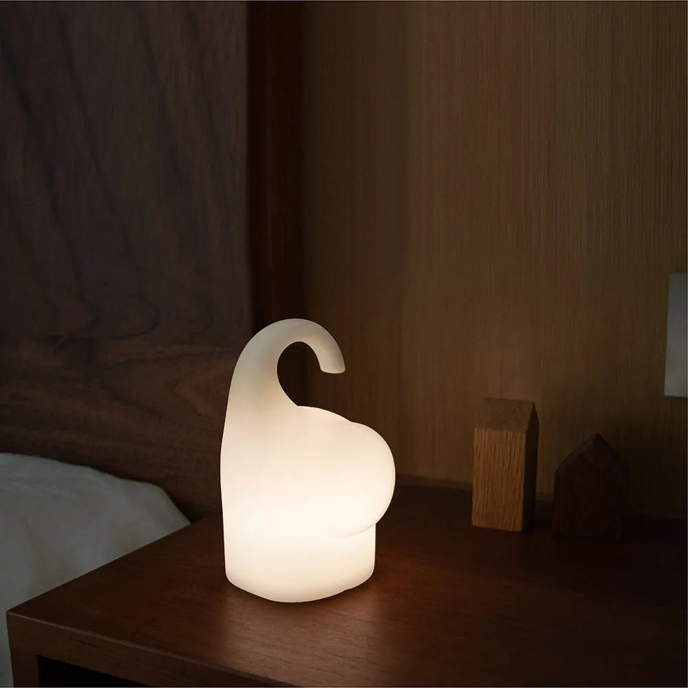 DOMI Elephant silicone night light with warm white glow on a bedside table