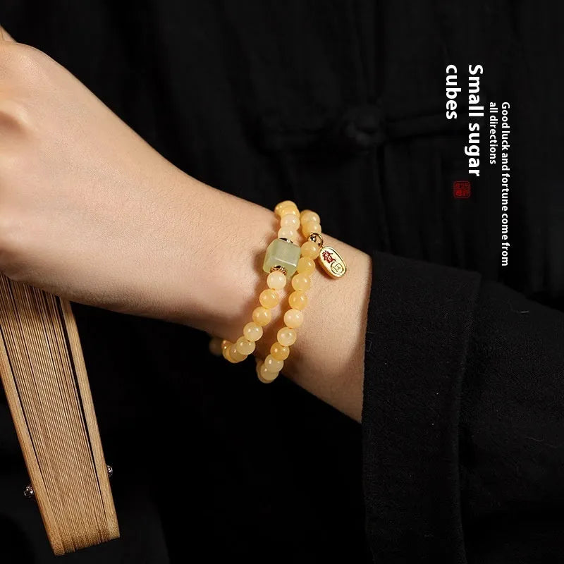 Women's hand-woven topaz bracelet with 6mm mantra barrel beads and square jade charms