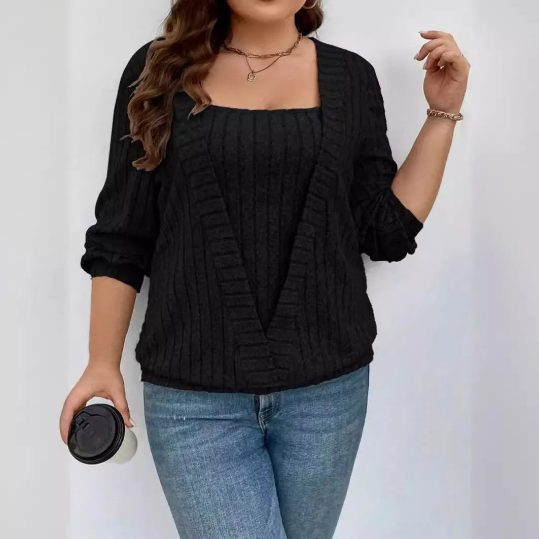 Solid colour ribbed knit V-neck false two-piece suit top with long sleeves on a hanger.
