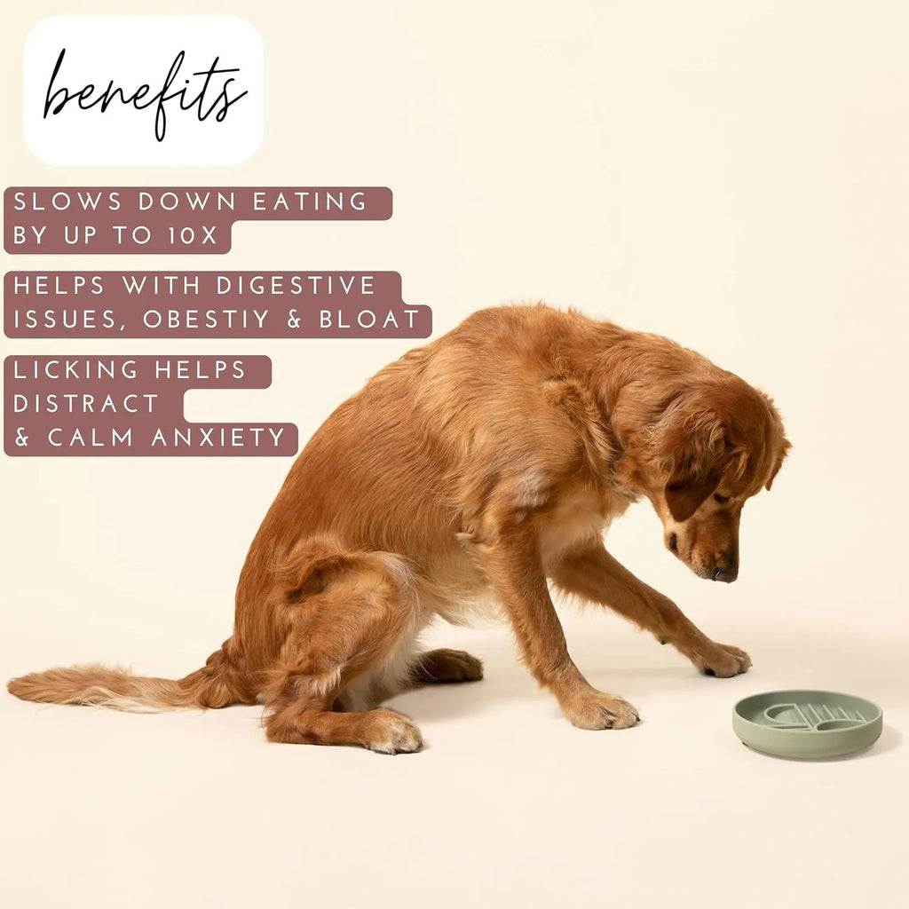 Beige silicone dog slow feeder bowl with ridges, shown next to a grey blue version on a wooden floor.