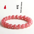 Close-up of a red rhodochrosite crystal bracelet with geometric beads and a Longevity Lock clasp.