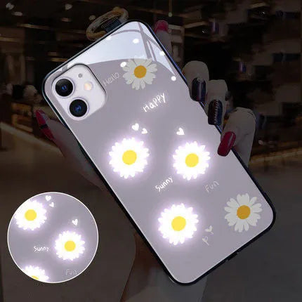 Luminous purple and white daisy iPhone case with voice-activated colour lights on a phone.