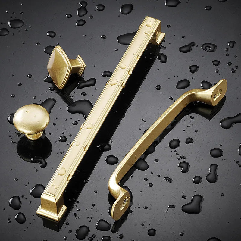 Modern gold T-shape single-hole cabinet handle made of aluminium alloy.