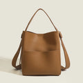 Bucket-style PU messenger bag with sewing line detail, available in black, brown, and elephant gray, on a plain background