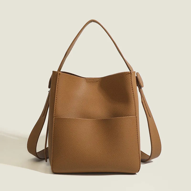 Bucket-style PU messenger bag with sewing line detail, available in black, brown, and elephant gray, on a plain background