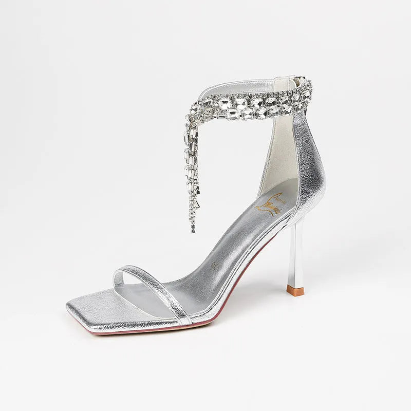 Women's black high heel sandals with 8cm heel, ankle strap buckle, and square open toe on a plain background.