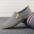 Men's low-top canvas sneakers in grey, black orange, or khaki with a vulcanised rubber sole.