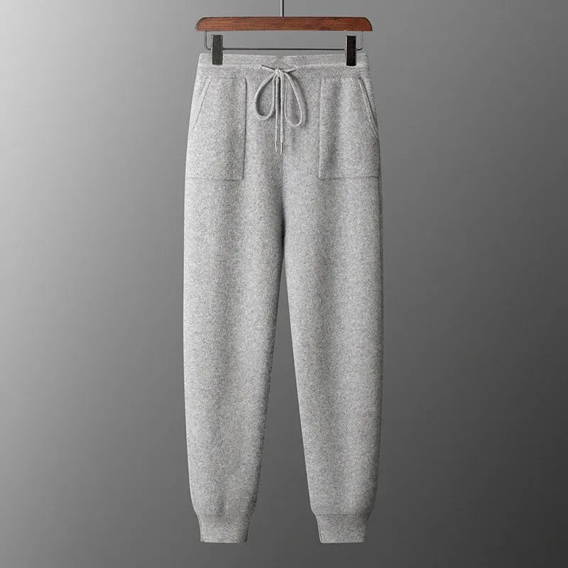 Men's light grey cashmere hooded sweatshirt and matching trousers set laid flat.