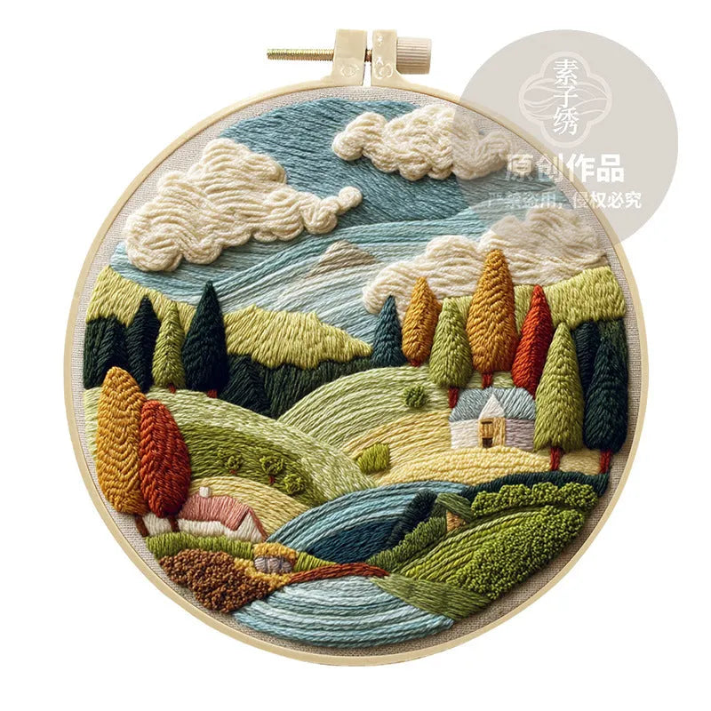 Embroidery DIY kit with landscape designs on cotton fabric, bamboo frame, thread, and needles