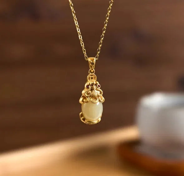 Hetian jade antique gold pendant necklace with cartoon pi xiu design and cross chain.
