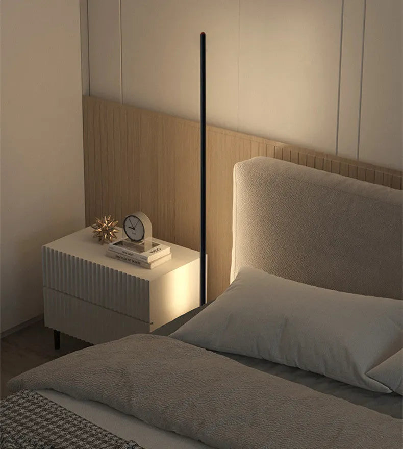 Vertical aluminium alloy floor lamp in modern simple style placed beside a sofa.