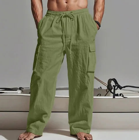 Man wearing loose beige cotton wide-leg casual trousers with a relaxed fit.