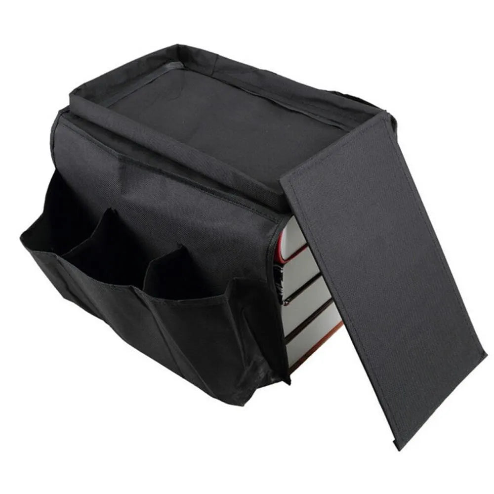 Black Oxford fabric sofa armrest organiser bag with 6 pockets on a couch handrail