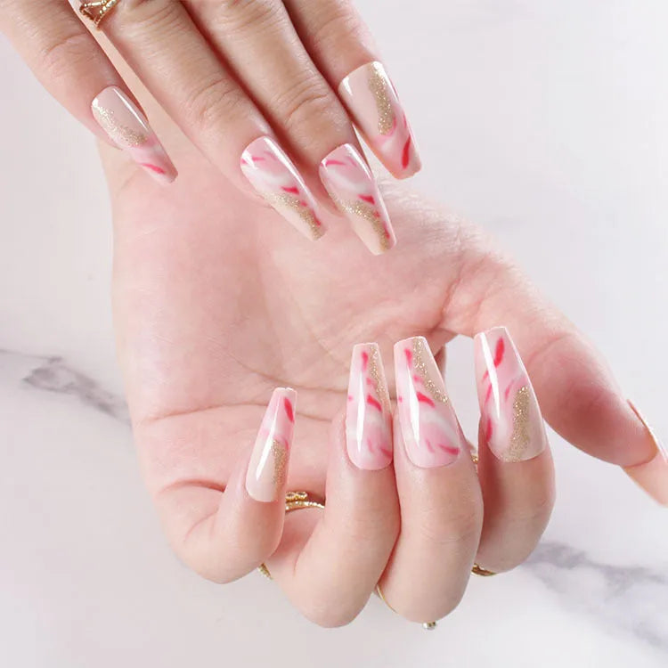 Wearable manicure set showing 24 false nails in various patterns with glue bottle