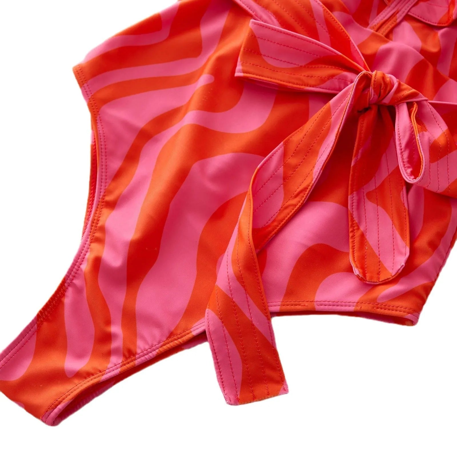Women's deep V-neck one-piece swimsuit with ruffled shoulders and mesh stitching detail in a printing pattern.