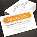 Box of paper illegal parking reminder cards showing a middle finger graphic.