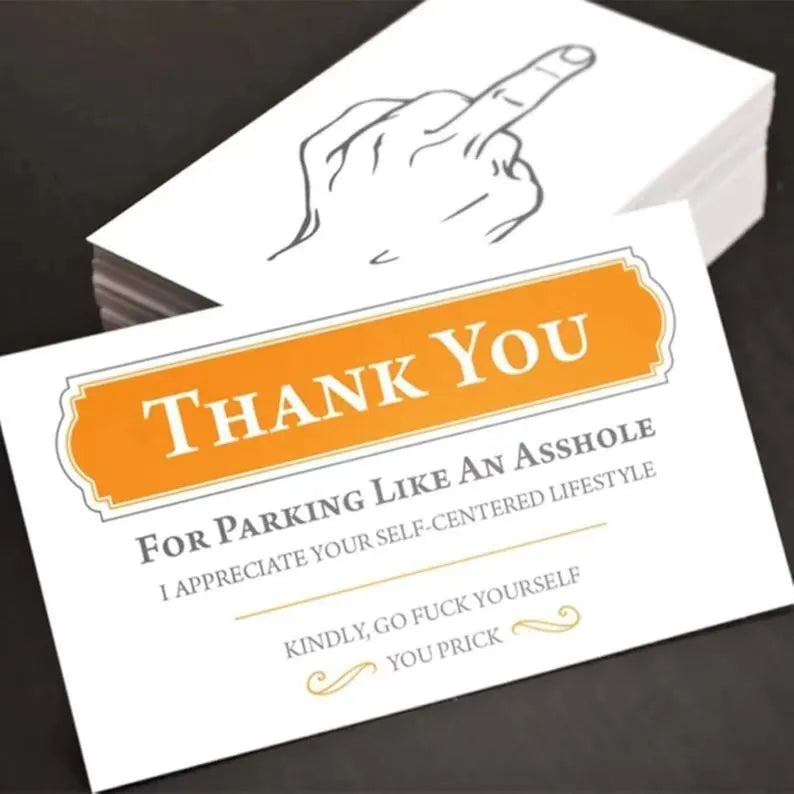 Box of paper illegal parking reminder cards showing a middle finger graphic.