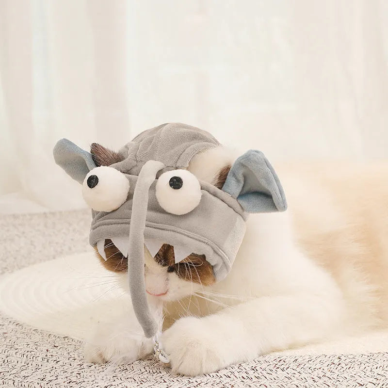 Grey dinosaur-themed head-mounted cat toy with feathers and big eye fish design on adjustable band