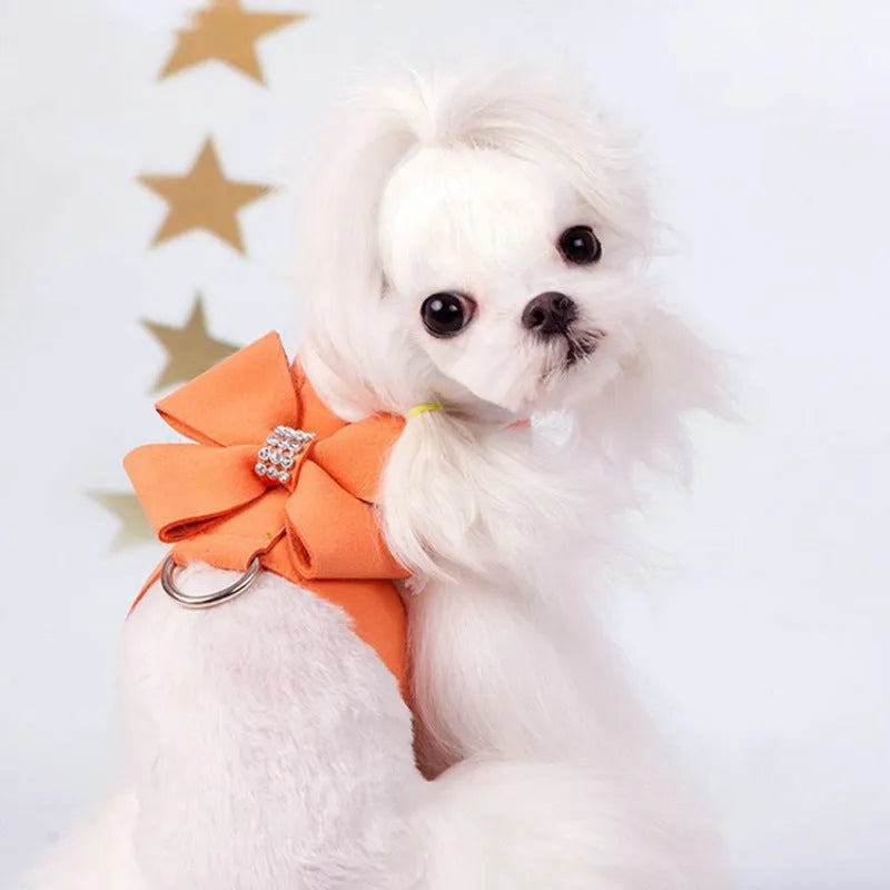 Pink microfiber puppy chest strap with a bowknot, showing the D-ring leash clip.