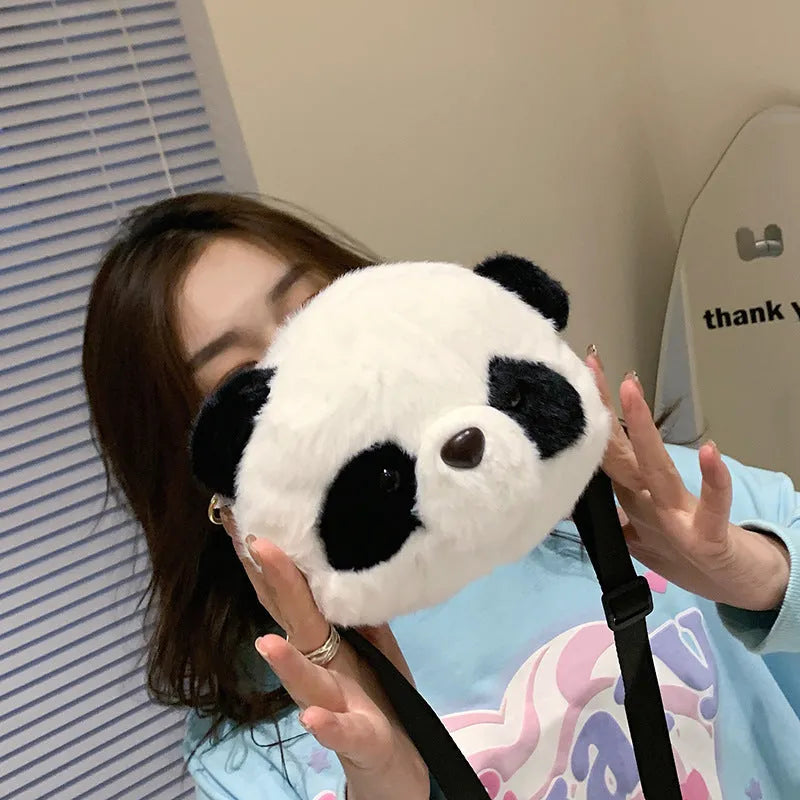 Soft plush crossbody bag with panda head design, cylindrical shape.