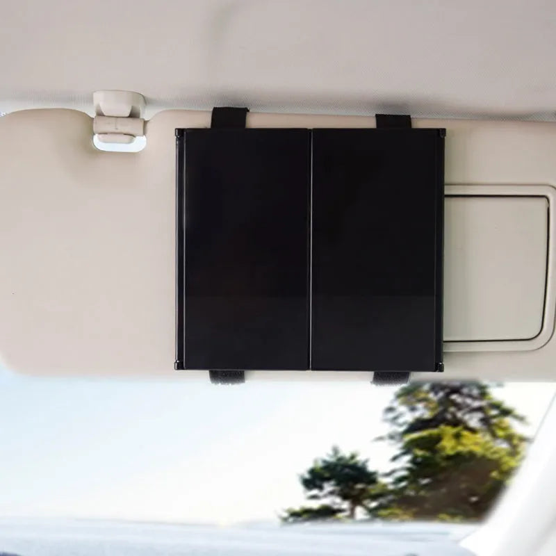 Silver folding makeup mirror shown both closed and opened, next to a car sun visor.