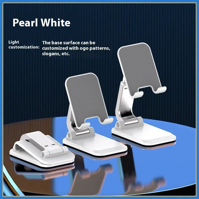 Foldable mobile desktop stand in black, showing smartphone placed on its universal bracket.