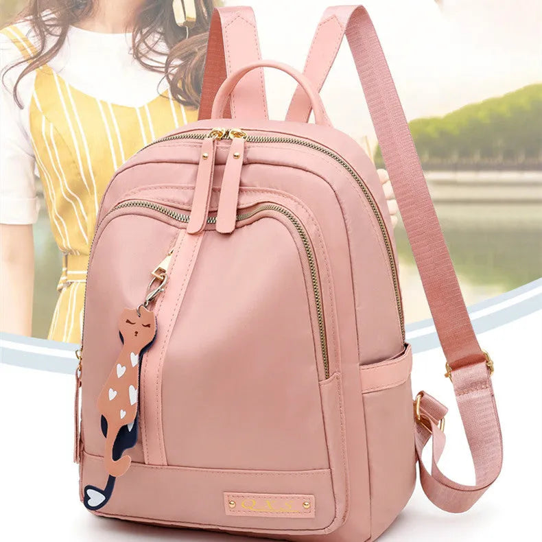 Black square nylon casual backpack with double shoulder straps and a front pocket.