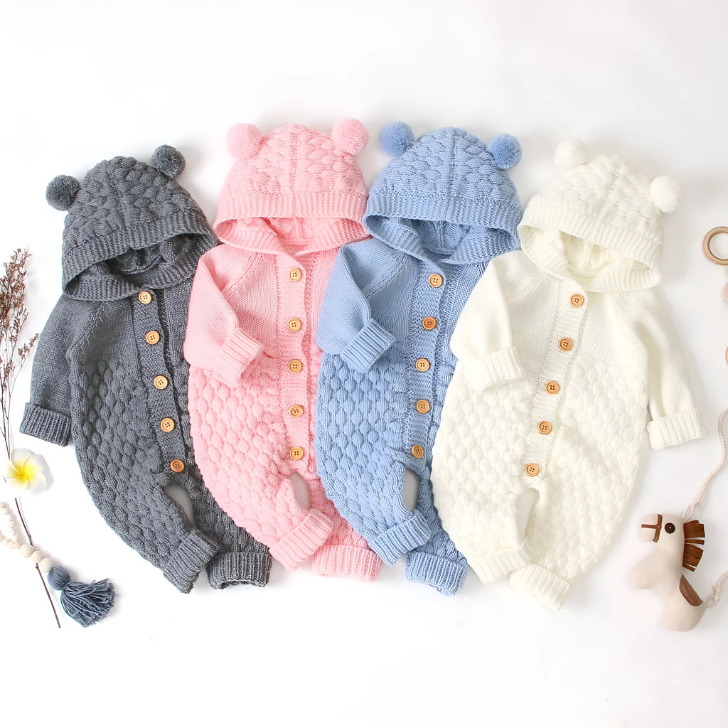 Hooded knitted jumpsuit in 100% acrylic fabric available in multiple colours with long sleeves