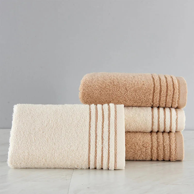 Beige and brown cotton towel set showing bath towel, hand towel, and face cloth sizes