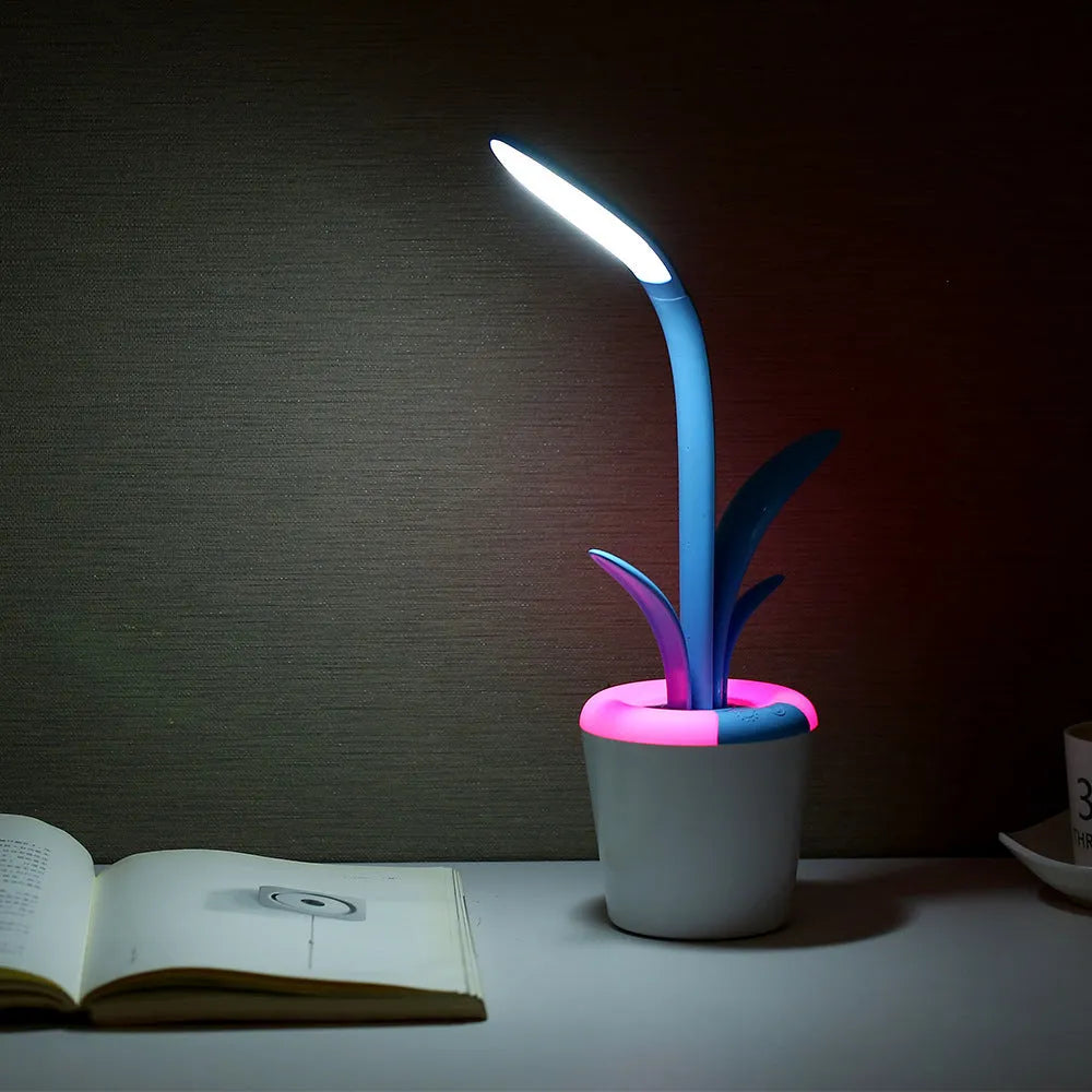 Modern rechargeable desk lamp with plant shape design in pink, showing touch control on a wooden end table