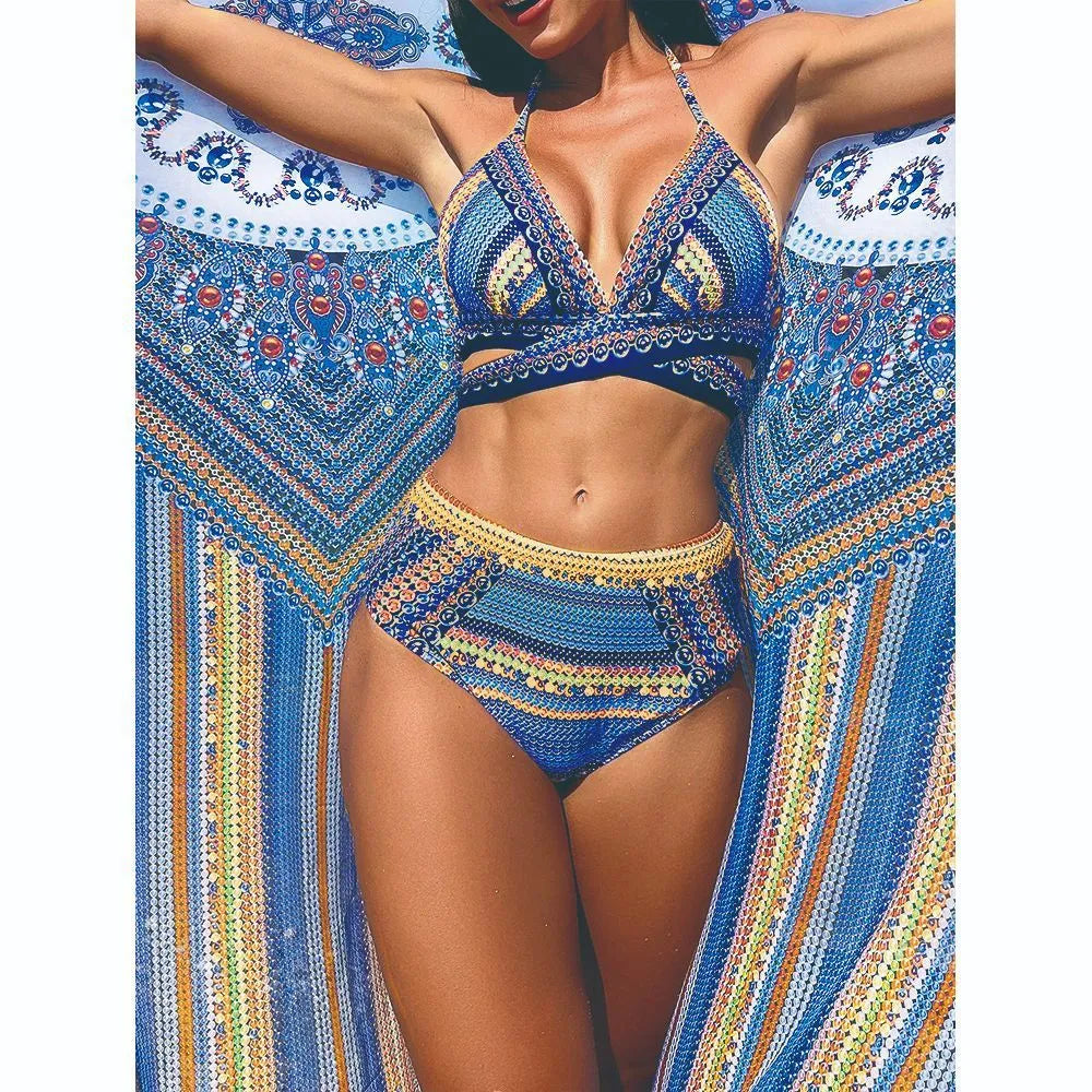 Women's blue three-piece bikini set with cross bandage bra, high-waisted briefs, and a matching smock.