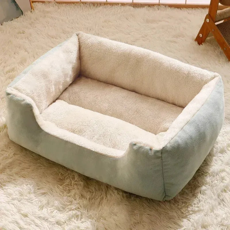 Soft short plush pet bed for cats and dogs in grey, shown in a large size on a wooden floor.