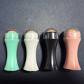 Volcanic stone facial roller for oily skin control in black, green, pink, and white colour options.