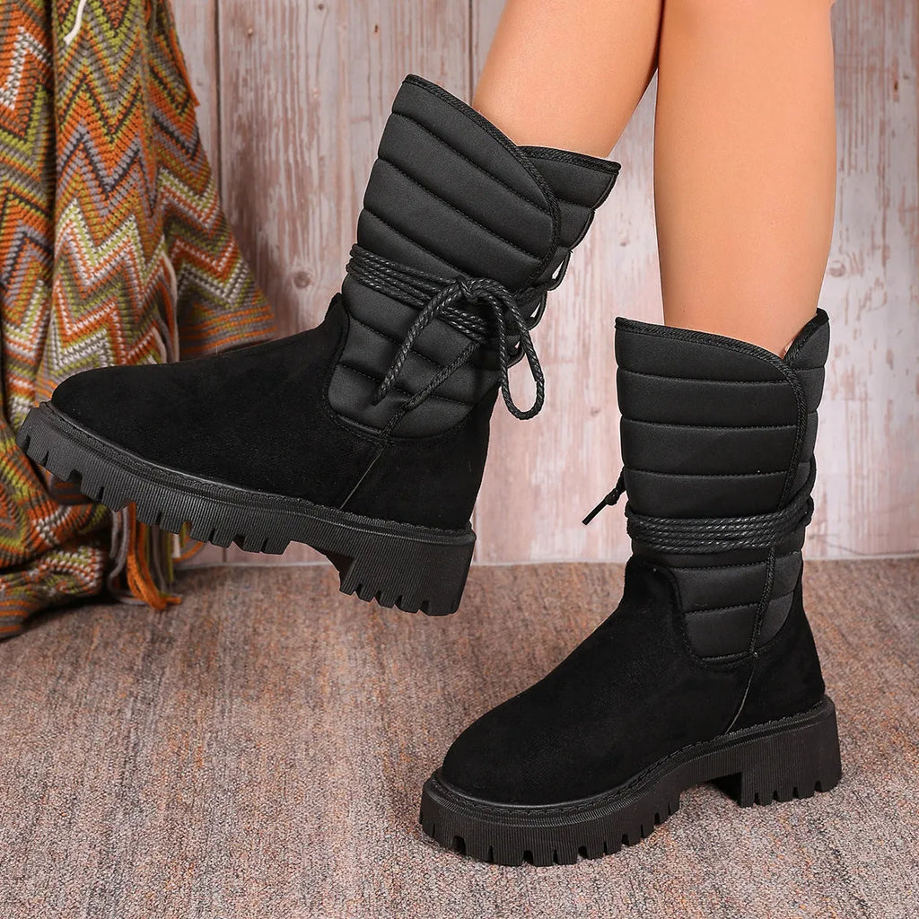 Women's black suede chunky heel snow boots with lace-up front and fleece lining.