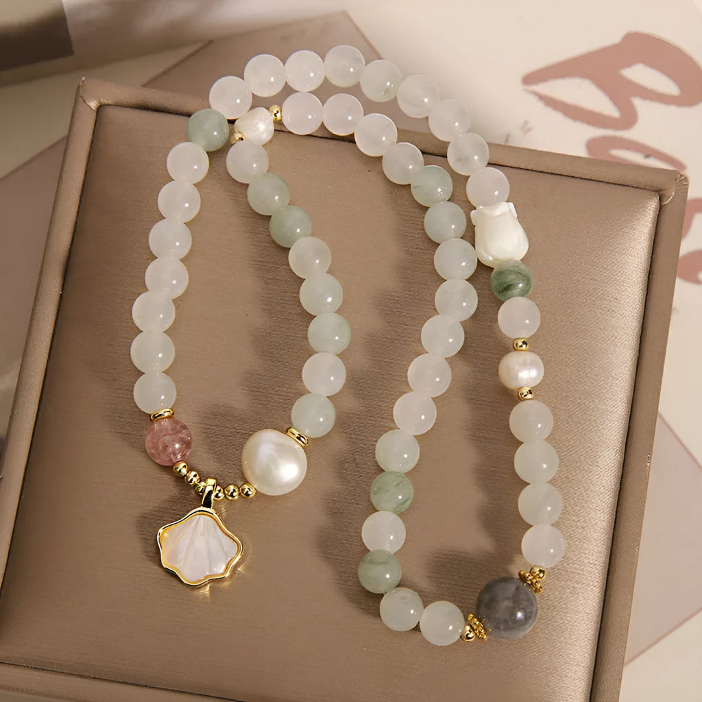 Women's crystal bracelet with Tianshan Jade ginkgo leaf pendant and gold-plated inlay.