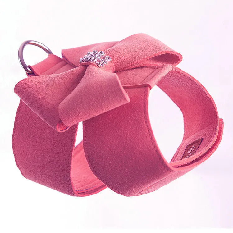 Pink microfiber puppy chest strap with a bowknot, showing the D-ring leash clip.