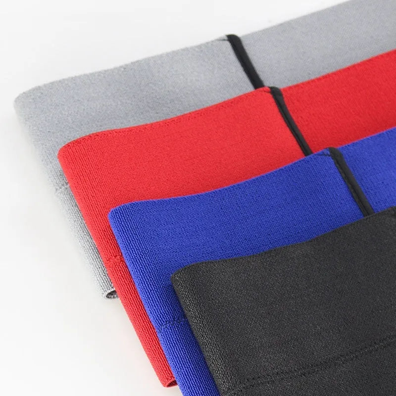A black elastic elbow support bandage or compression sleeve worn on an arm.