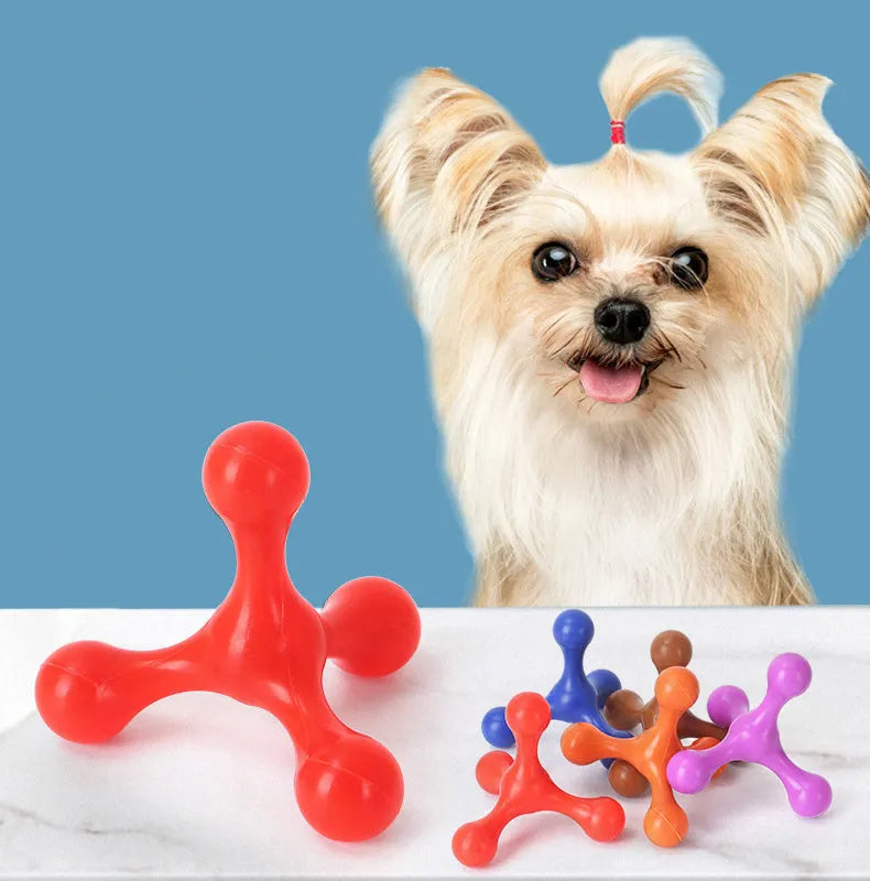 Blue silicone dog chew toy shaped like a bone with three legs, shown next to a small puppy.