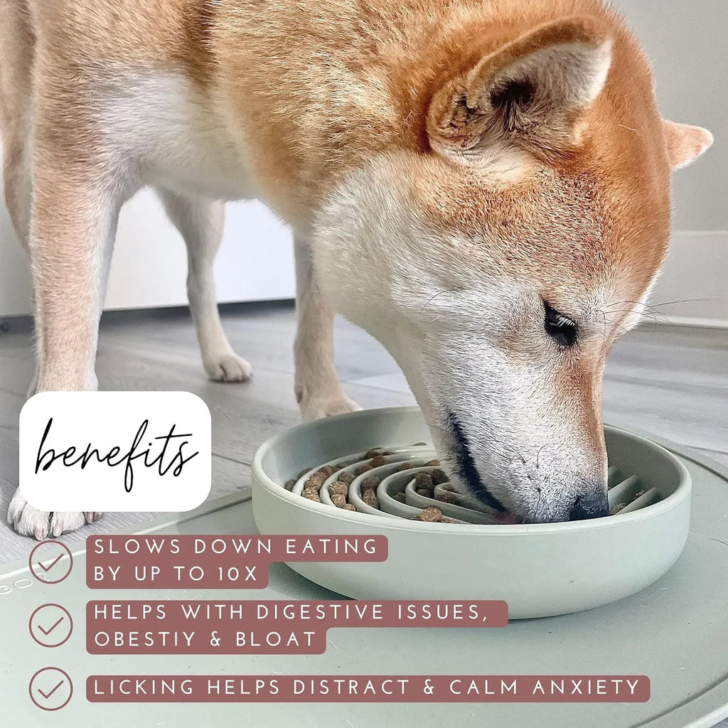 Beige silicone dog slow feeder bowl with ridges, shown next to a grey blue version on a wooden floor.