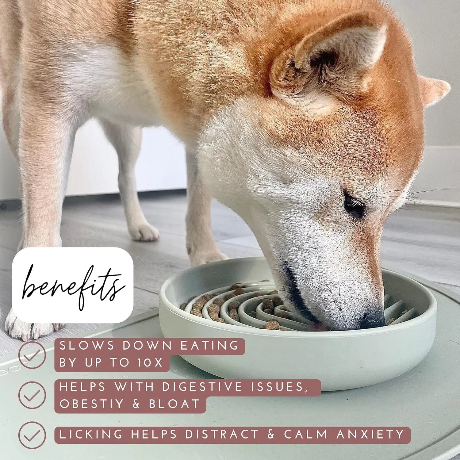 Beige silicone dog slow feeder bowl with ridges, shown next to a grey blue version on a wooden floor.